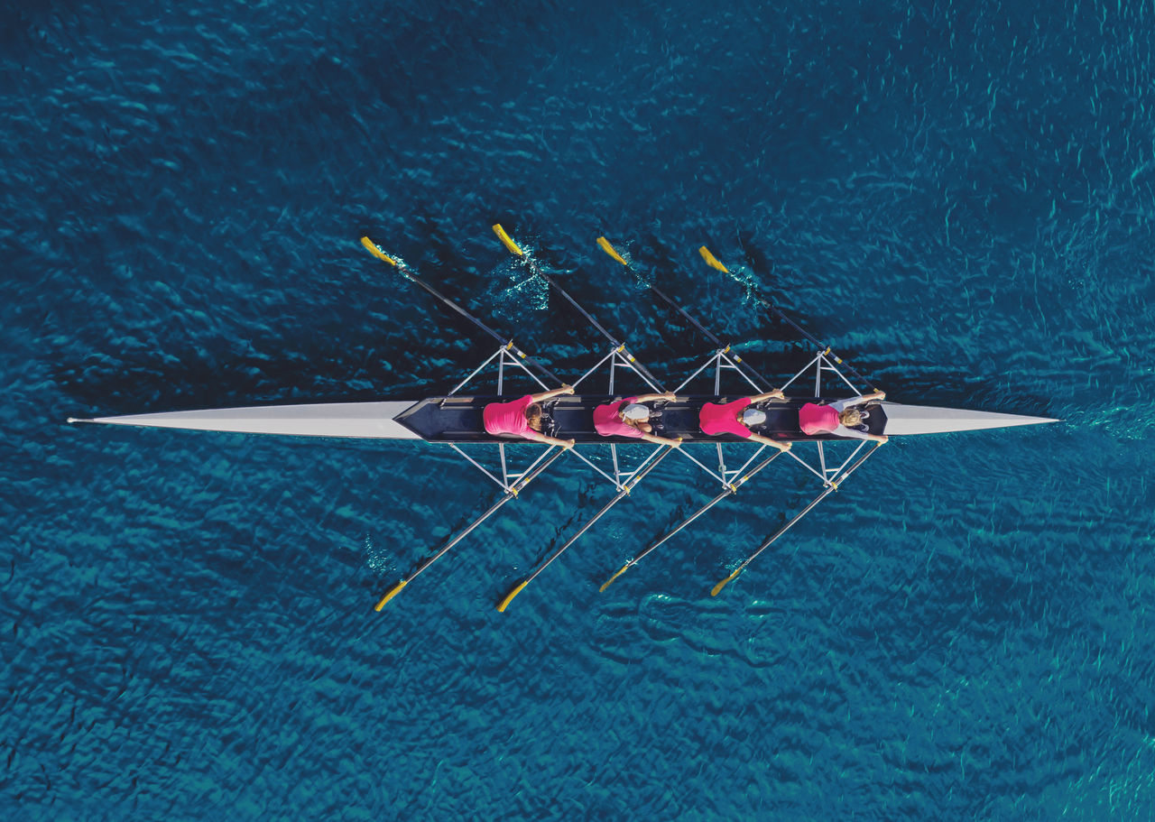 Women's rowing team on blue water, top view; Shutterstock ID 794460844; NP: Publication cover for "Insights from Skills Strategies in the European Union"